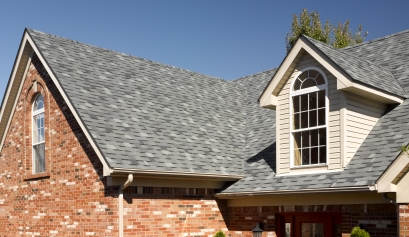 Multicolored gray shingle roof on brick house